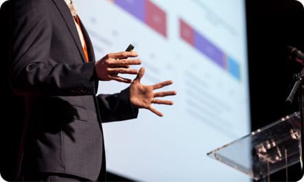A man presenting at a conference
